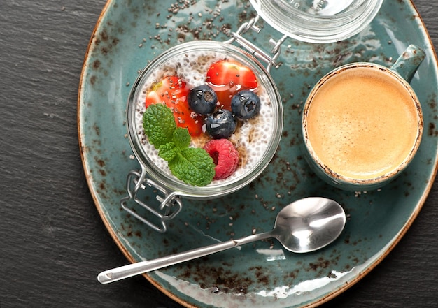 Chia pudding dessert with berries and coffee Espresso top view