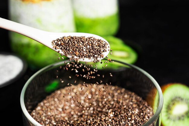 Chia pudding with kiwi and granola isolated on dark background Chia pudding mint and kiwi