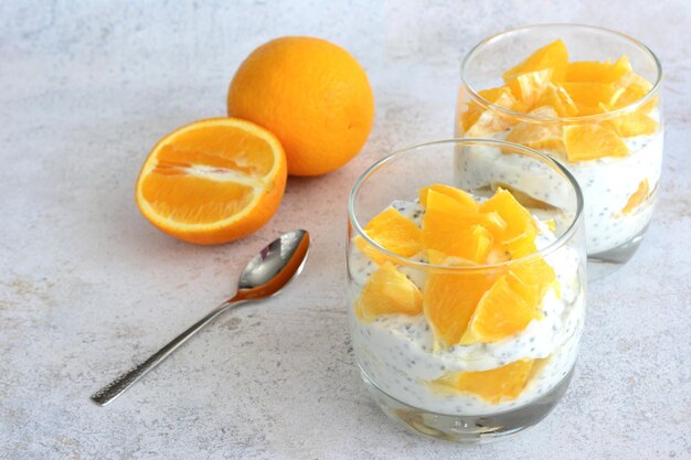 chia pudding with orange fruit slices in drinking glass