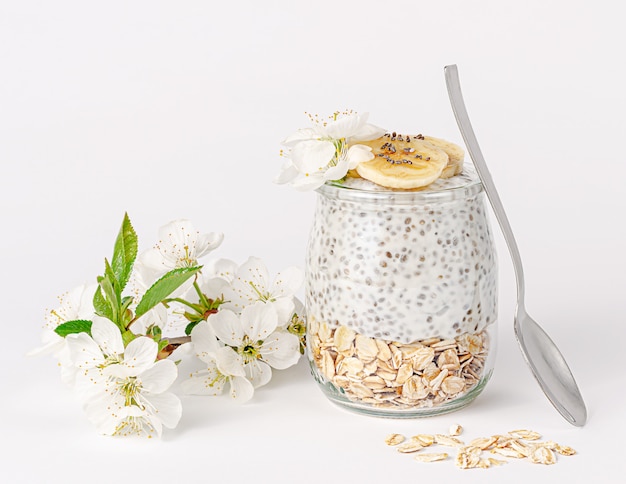 Chia pudding with yogurt, banana and oats Healthy eating concept.