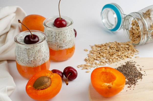 Chia puddings with apricot and sweet cherry on white 