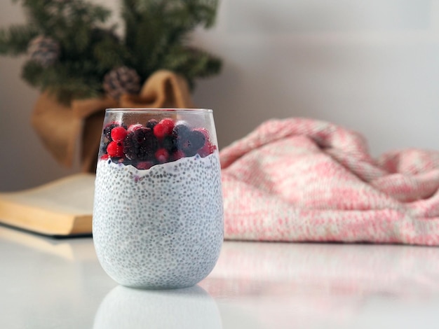 Chia seed pudding with wild berries in a big glass