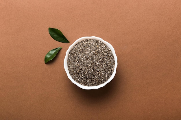 Chia seeds in bowl on colored background Healthy Salvia hispanica in small bowl Healthy superfood