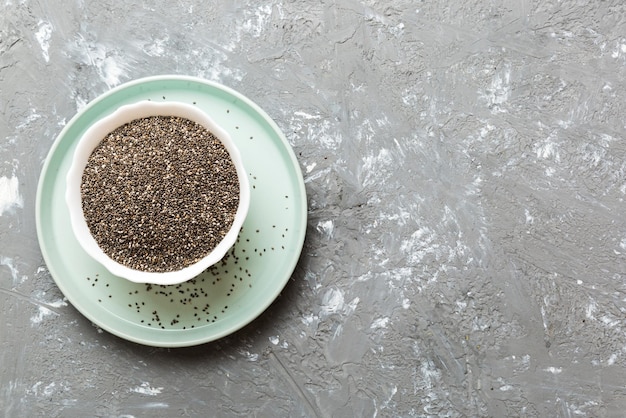 Chia seeds in bowl on colored background Healthy Salvia hispanica in small bowl Healthy superfood