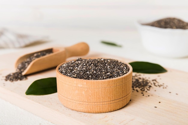 Chia seeds in bowl and spoon on colored background Healthy Salvia hispanica in small bowl Healthy superfood