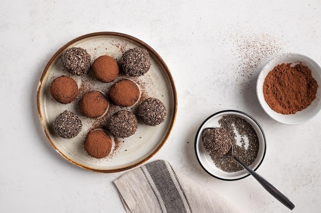 Chia seeds cacao bliss balls on ceramic plate Vegan protein energy balls