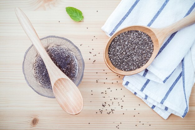 Chia seeds  for diet food ingredients setup on wooden background.