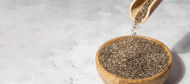 Chia seeds fall in wooden bowl healthy superfood rich in omega 3 fatty acids dry healthy natural
