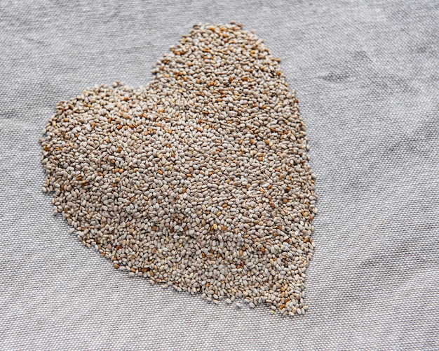 Chia seeds on a grey textile background.