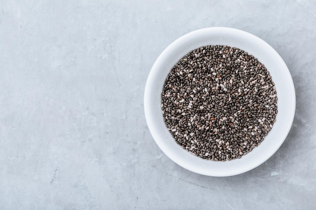 Chia seeds Organic Dry Black and White Chia Seeds in bowl on gray stone background