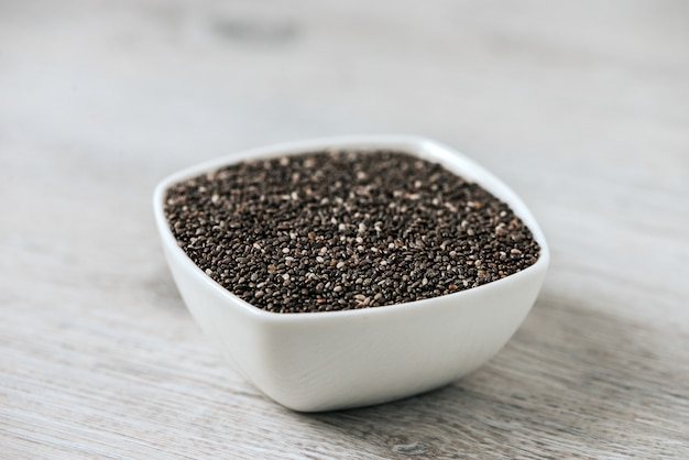 Chia seeds in a white ceramic bowl. 