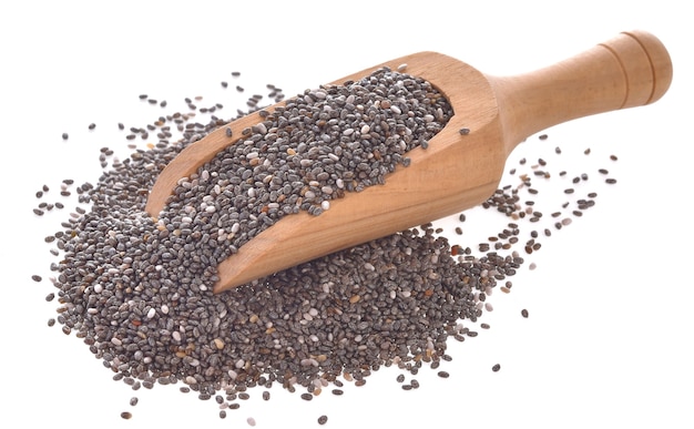 Chia seeds in wood scoop on white background