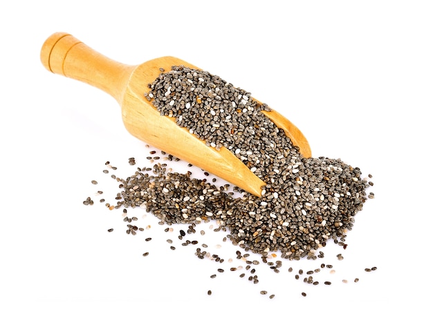 Chia seeds in wooden scoop on white background