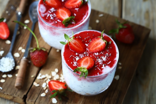 Chia yogurt in cups with strawberries and seeds