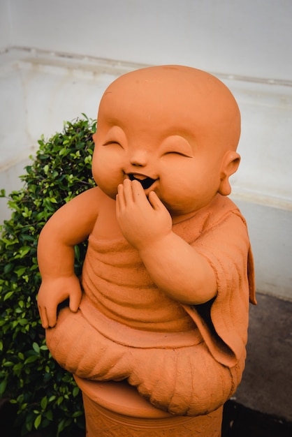 Chiang Mai, Thailand - June 10, 2016: Laughing statue of monk made of clay as a decor on the streets of Chiang Mai