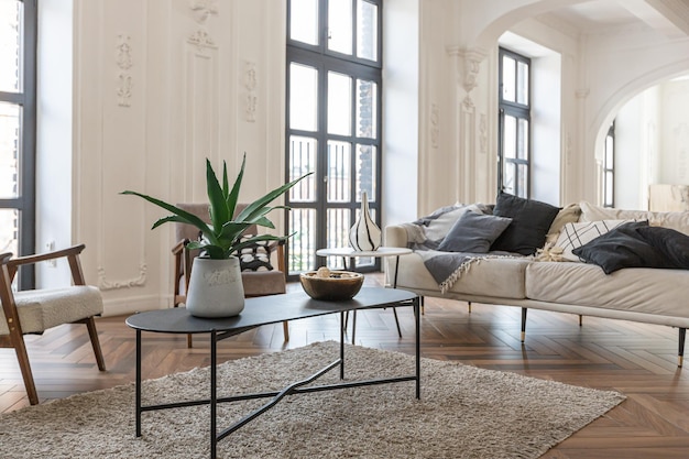 a chic expensive bright interior of a huge living room in a historic mansion with arched arches columns and white walls decorated with ornaments and stucco