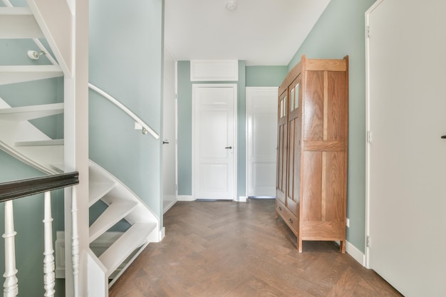 Photo a chic hall with soft blue walls and a spiral staircase