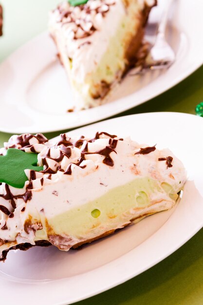 Chic pie crust with chic mousse and white chic mint mousse with whip cream on top.