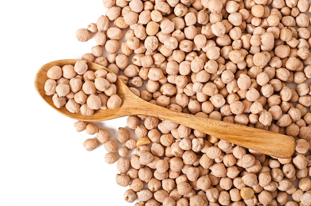 Chick-pea in wooden bowl on wooden table close up