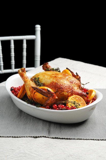 Chicken baked with oranges and cranberry in oven