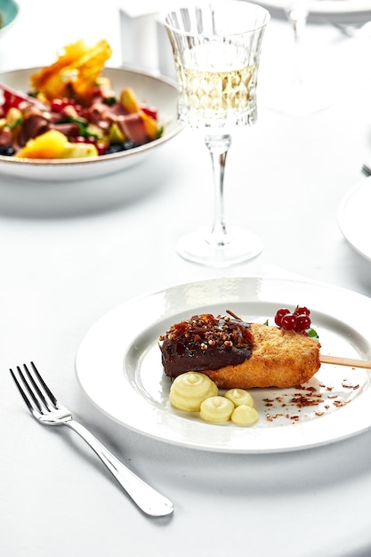 Chicken balls with mashed potatoes. Beautifully decorated catering banquet table. White backgraund.