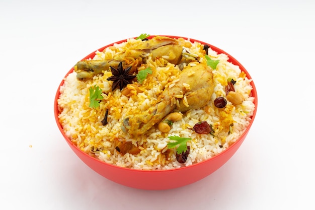 Chicken biryani made using jeera rice and spices arranged in a red table ware