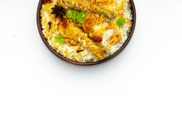 Chicken biryani made using jeera rice and spices arranged in a wooden tableware