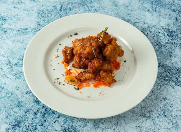 chicken bites served in plate isolated on background top view of italian food