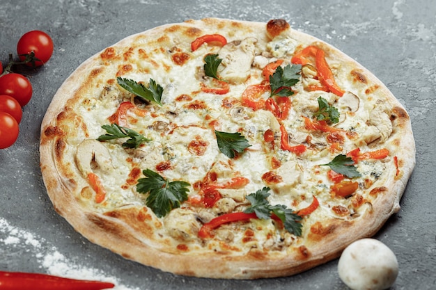 Chicken-blue pizza with tomato, mozzarella and Dor Blue cheeses on gray