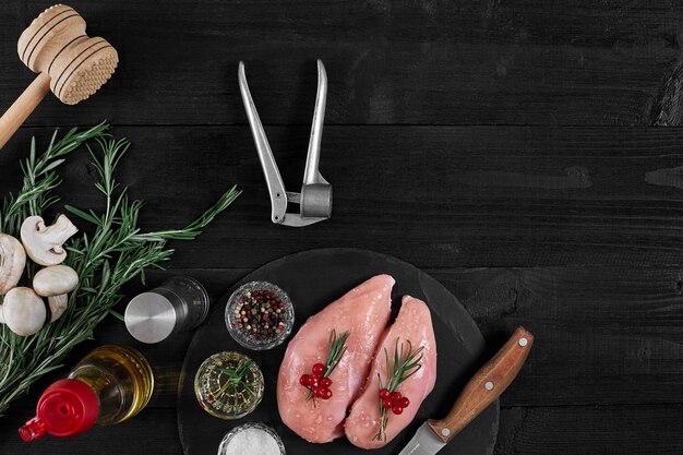 chicken breast on a cutting board with herbs and different vegetables on rustic wooden background top view copy space still life flat lay