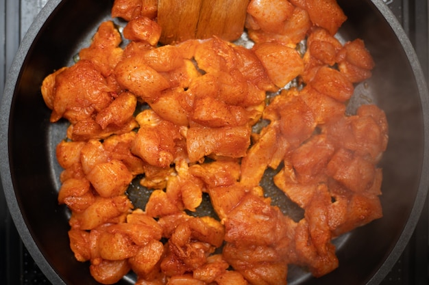 Chicken breast frying on pan