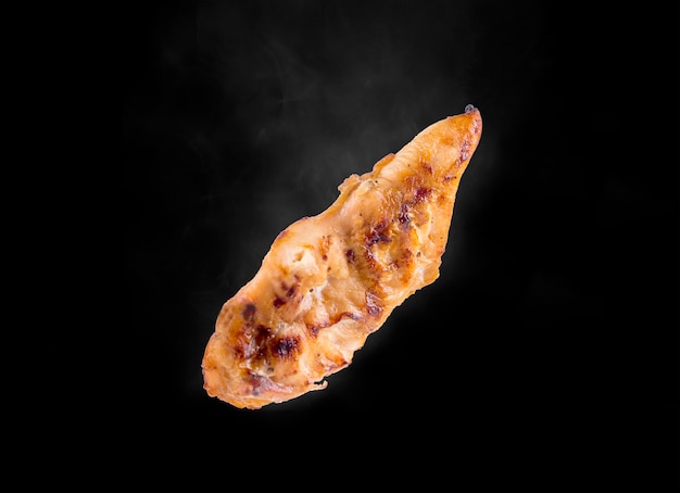 Chicken breat grill with smoke on the black studio