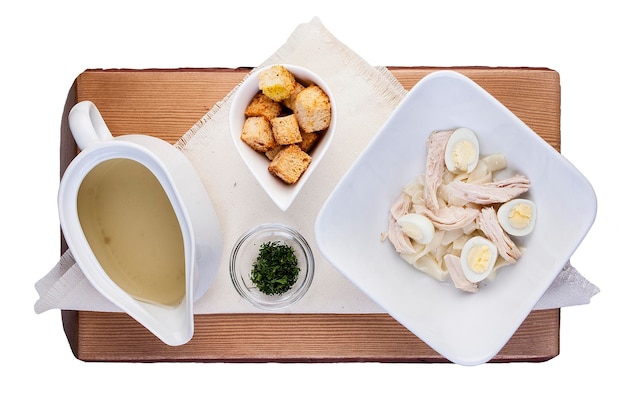 Chicken broth with quail egg On a wooden Board The view from the top