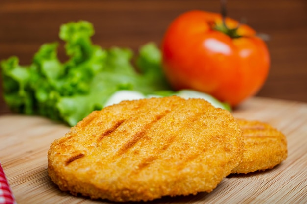 Chicken burger, salad, bread.