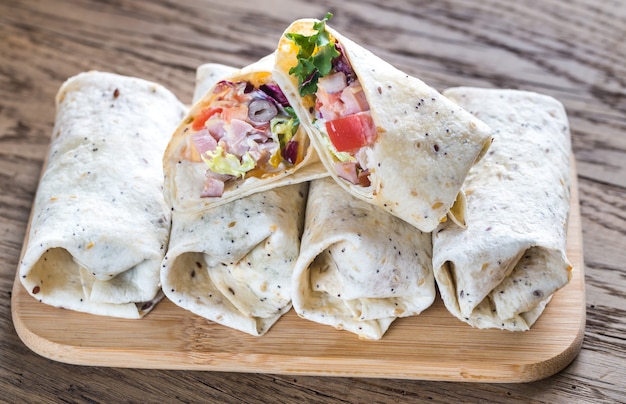 Chicken burritos on the wooden surface