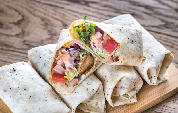 Chicken burritos on the wooden surface