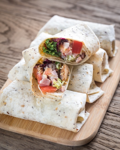 Chicken burritos on the wooden surface