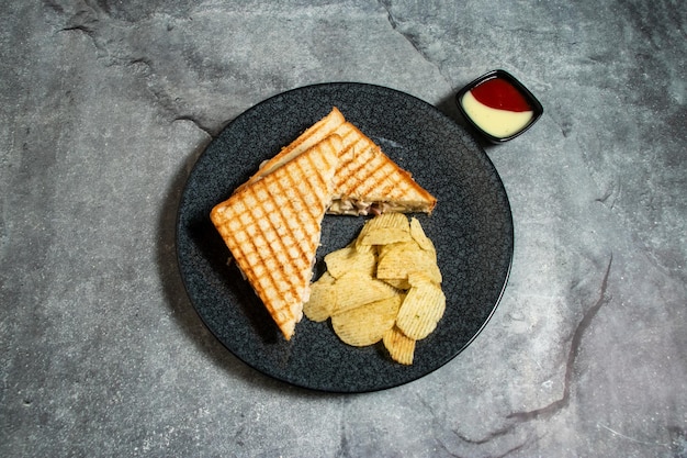 chicken Cheese mushroom sandwich with chips and mayo dip sauce served in plate isolated on background top view of breakfast food indian spices