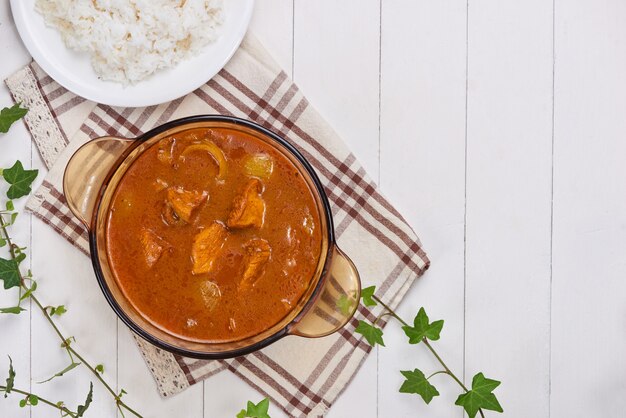 Chicken curry with spice on wooden background