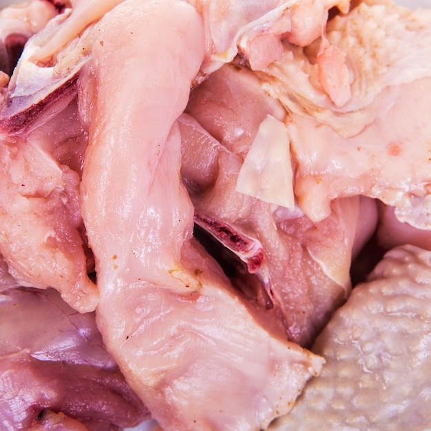 Chicken, cut into pieces on a white background.