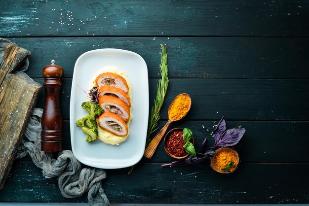 Chicken Cutlet with Potatoes Cutlet in Kiev In the plate On a wooden background Top view Free space for your text