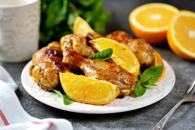 Chicken drumsticks baked with orange and mint