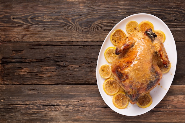 Photo chicken or duck baked in oven on festive dinner table