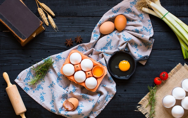 Chicken egg on a dark on wood