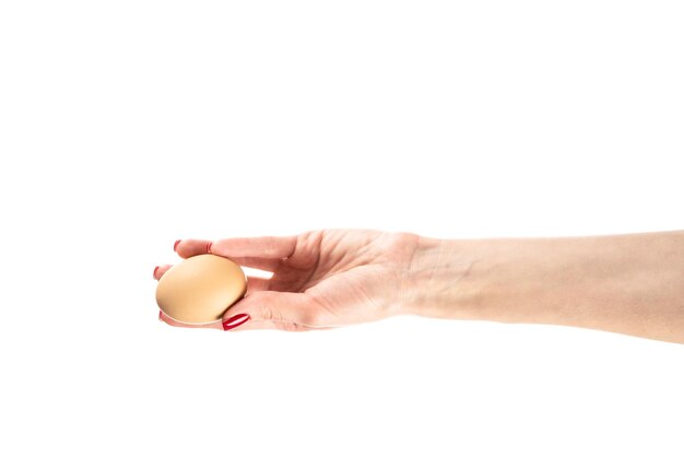 Chicken egg in female hand isolated on white background