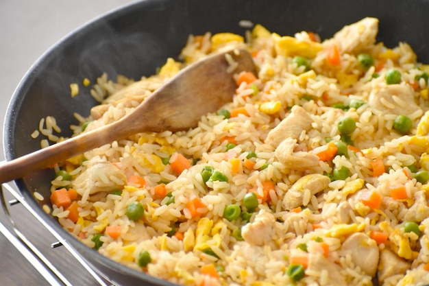 Chicken and egg fried rice in a pan