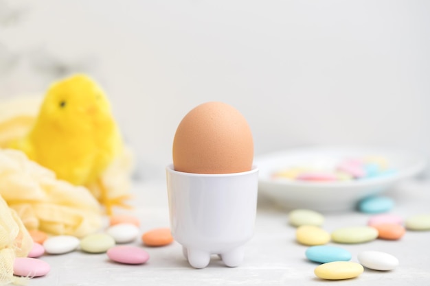 Chicken egg with sweets on gray ceramic