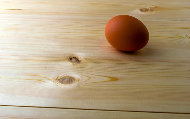 Chicken egg on a wooden table