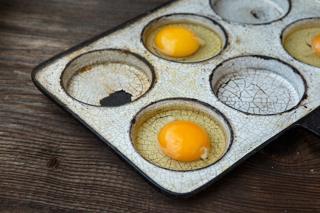 Chicken eggs in a frying pan Rustic style