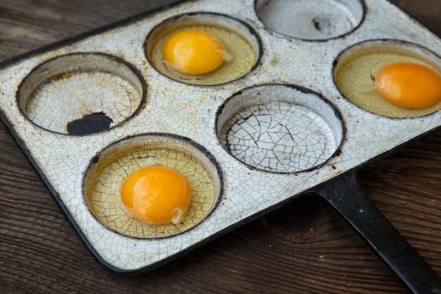 Chicken eggs in a frying pan Rustic style